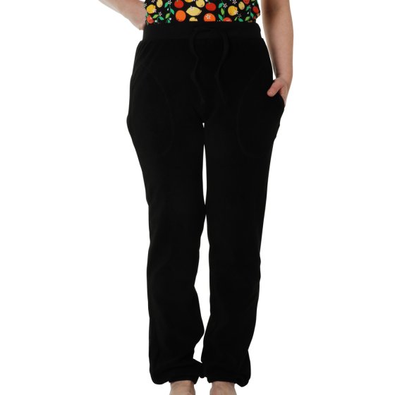 Close up of woman wearing the DUNS Sweden organic cotton terry trousers in black on a white background