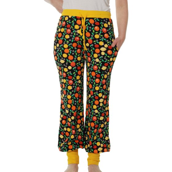 Close up of woman stood wearing the DUNS Sweden organic cotton adult baggy pants on a white background
