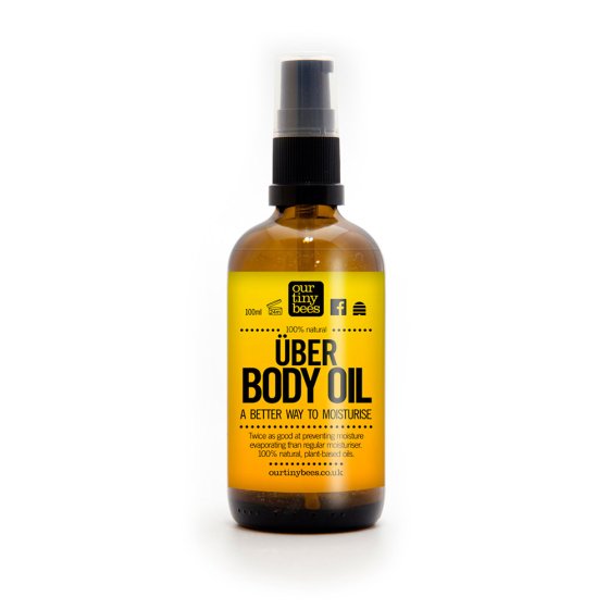 Our Tiny Bees Über Body Oil in bottle on white background