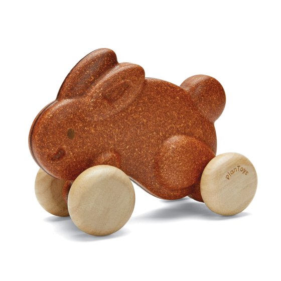 Plan Toys eco-friendly wooden push along bunny toy in brown on a white background