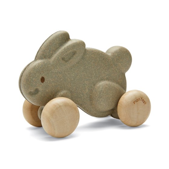 Plan Toys eco-friendly wooden push along bunny toy in grey on a white background