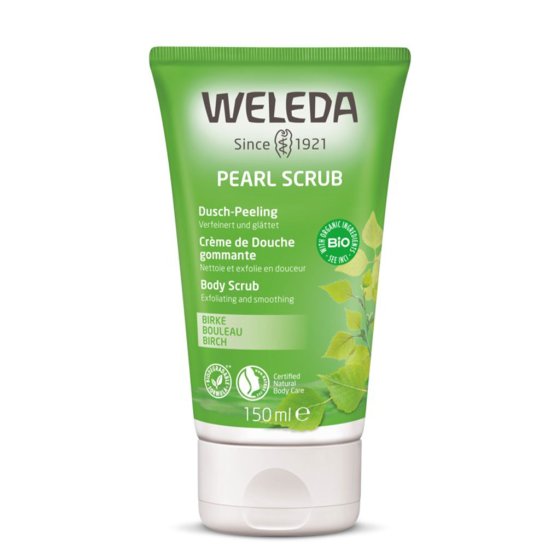 Green bottle of Weleda natural birch body scrub exfoliator on a white background