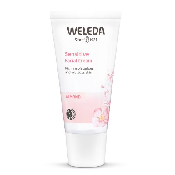 Bottle of Weleda natural almond sensitive face cream on a white background