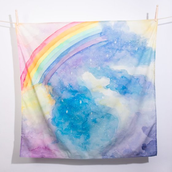WonderCloths childrens organic play silk with the magical sky design hanging from a rope line in front of a white wall