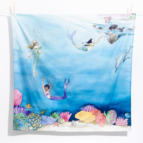 Wondercloths childrens tales of mermaids play cloth hanging from a rope line in front of a white background