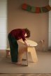 Child assembling the babai sustainable flat packed wooden table
