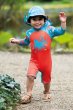 a child wearing teal legionnaire hat with the what lies below print from frugi