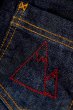 Close up of a mountain shaped stitch on the Frugi kids lumberjack lined jeans 