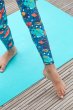 Close up of a childs leg wearing the Frugi eco-friendly stretchy space themed leggings