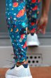 Close up of someone tying their shoes wearing the Frugi eco-friendly stretchy space print cosmo leggings