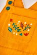 Frugi gold cold close up of pocket embroidery