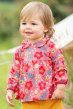 Blond toddler wearing scandi floral long sleeve peter pan collar top outside