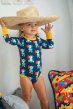 a child wearing navy blue long sleeve body with the dodo print and yellow cuffs and trim from maxomorra 