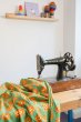 Maxomorra organic cotton lion craft pack laid out over a sewing machine on a wooden table