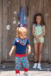 child wearing blue organic cotton rib pants with the watermelon print from maxomorra