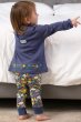back of a girl wearing  long sleeve blue tunic with colourful star embroidery along the hem and co-ordinating blue cuffed leggings in the Cosmic Weather print from piccalilly