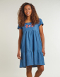 a woman wearing maternity chambray dress with the floral applique from frugi
