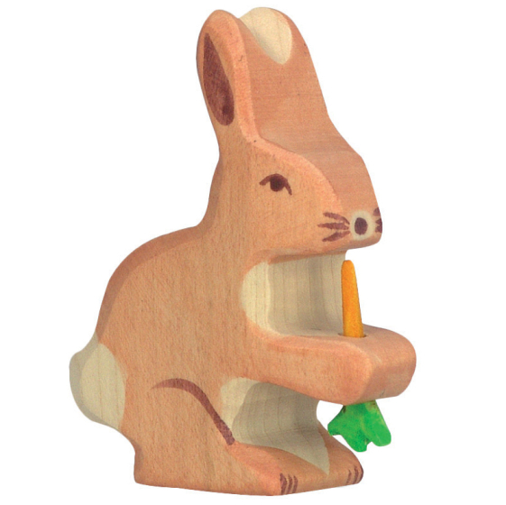 Holztiger hare with carrot figure pictured on a plain background