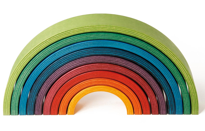 9 piece Naef wooden stacking rainbow on a white background.