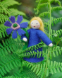 Close up of an Ambrosius eco-friendly collectable Cornflower doll in some green plants