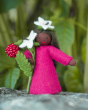 Close up of the Ambrosius eco-friendly collectable felt raspberry doll on a rock in front of a green background