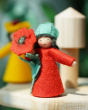 An Ambrosius poppy boy felted figured placed on a Grimm's wooden display stand 