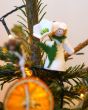 Ambrosius collectable christmas rose fairy figure in a christmas tree behind a slice of dried orange
