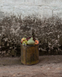 Metal bucket full of real fruit and a Babai sustainable wooden pear toy on the top
