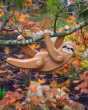 Close up of the Bajo solid wooden sloth toy figure hanging from a tree branch