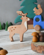 The deer from the Bajo Wild Animals Forest Set seen in a play scene with a blue Bajo truck in the background. The squirrel figure is seen siting on the truck. Grapat mandala pieces are placed in the background and at the front  