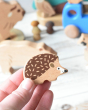 A hand can be seen holding up the hedgehog figure from the Bajo forest animals set  