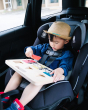 Child in a baby car seat wearing a brown hat, holding the Big Future eco-friendly wooden latch board