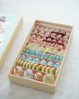 Billes & Co Rose Fairy Marble Box with 71 glass marbles in stunning pastel pink, red, orange, green and blue colours, in an open box on a white table top