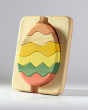 Bumbu sustainable wooden egg puzzle stood up on a grey background