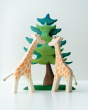 2 Ostheimer giraffe figures stood on a white background next to a Bumbu plastic-free spruce tree toy