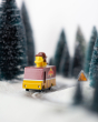 Close up of the Candylab collectable waffle truck toy on a toy road surrounded by miniature trees and snow