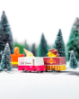 Candylab wooden ice cream and waffle truck toys on a toy road next to some miniature trees and snow