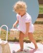A child collecting eggs from a colourful blanket and into the Olli Ella Rattan Berry Basket with Lining – Pansy Floral.
