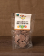 Cocoa Loco Fairtrade milk chocolate buttons in their plastic wrapping bag, on a wooden background