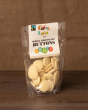 Cocoa Loco organic Fairtrade white chocolate buttons in their plastic bag on a wooden background