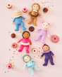 The Dinkum Doll Sweet Treat Collection. Sadie Sprinkles, Clara Cupcake, Darcy Donut, Franny Frosting, Bonnie Buttercream and Freya Fondant are all together on a light pink, sweet treat background