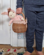 A child in navy blue clothes holding Bella Bunny in the Olli Ella rattan gumdrop basket