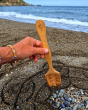 The bamboo spade from the Dr Zigs Beach Creativity Kit being used on a beach to create a mandala shape in the sand 