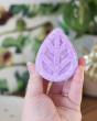 person holding a ecoliving solid shampoo bar in hand