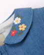 Close up of the embroidered flowers on the collar of the Frugi childrens emma chambray dress