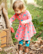 Young girl in the woods wearing the Frugi organic cotton piskie magic skater dress