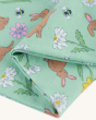 A close up view of the Frugi Little Libby Printed Leggings - Riverine Rabbits print, made from GOTS Organic Cotton. A beautiful spring-time print of yellow, white and pink flowers, bees, ladybirds and brown bunnies, and on a light mint green fabric. The l