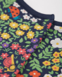 Close up of the poppers on the back of the Frugi organic cotton floral print dani dress