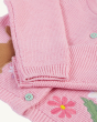 A clocer view of the arms and cuffs on the  pink, knitted Frugi Colby Cardigan - Jellyfish / Rabbit. Underneath the arms is the rabbit and flower applique details, and light grey buttons.