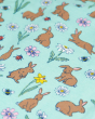 A close up of the print on the Frugi Organic Cotton Baby Gift Set - Riverine Rabbits. Made with GOTS Organic this is a beautiful mint green fabric and bunny, flower, bee and ladybird print